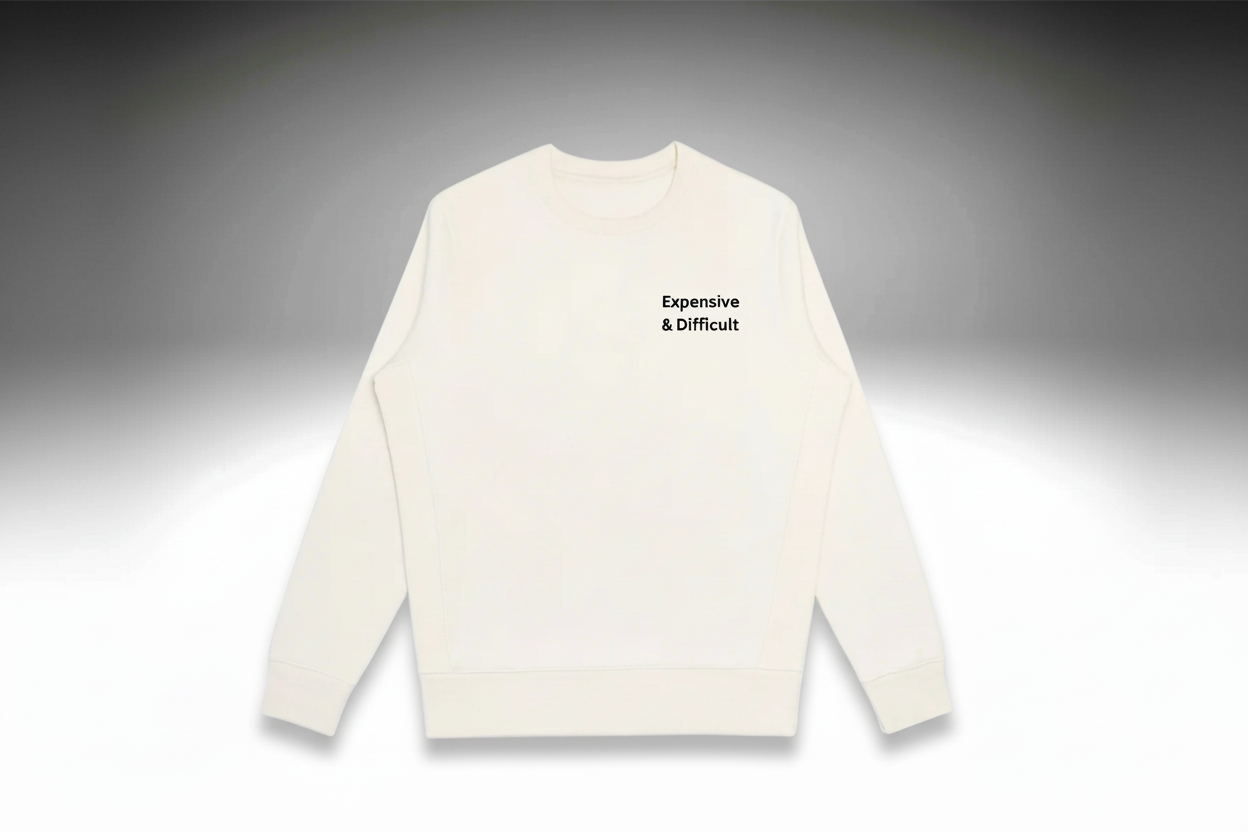 White sweater with text 'Expensive & Difficult' on a light gray background