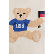 Woman wearing a white USA teddy bear crop top and denim mini skirt – perfect patriotic summer outfit