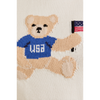 Woman wearing a white USA teddy bear crop top and denim mini skirt – perfect patriotic summer outfit