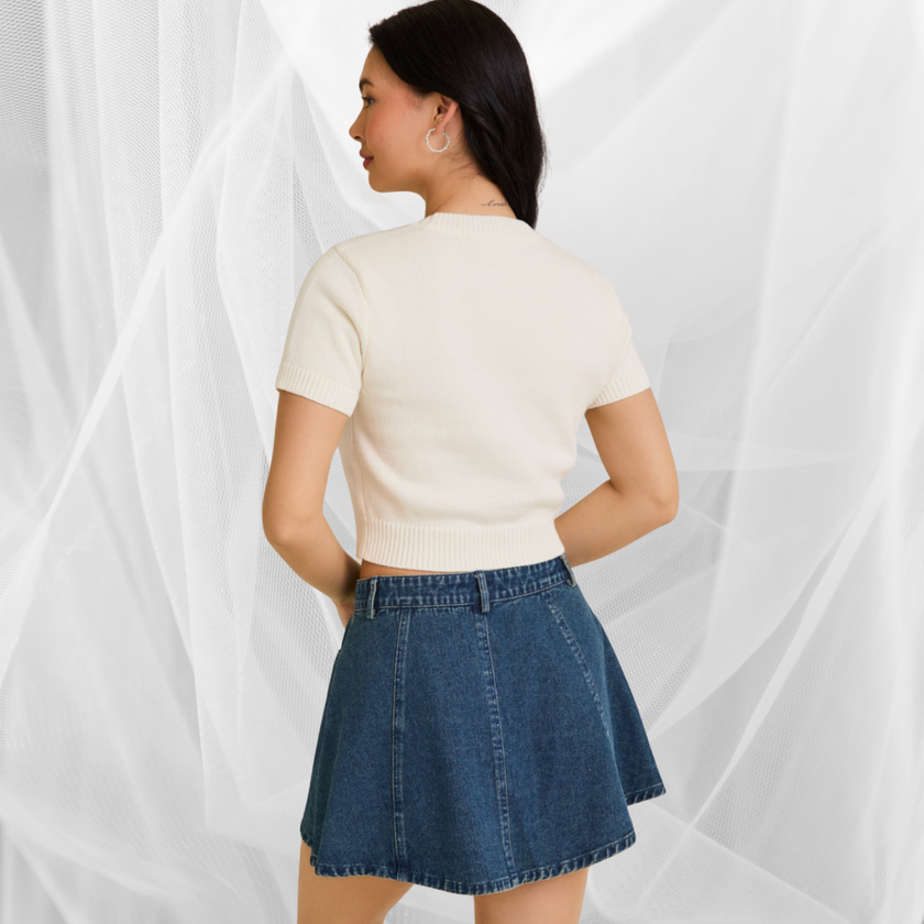 Woman wearing a white USA teddy bear crop top and denim mini skirt – perfect patriotic summer outfit