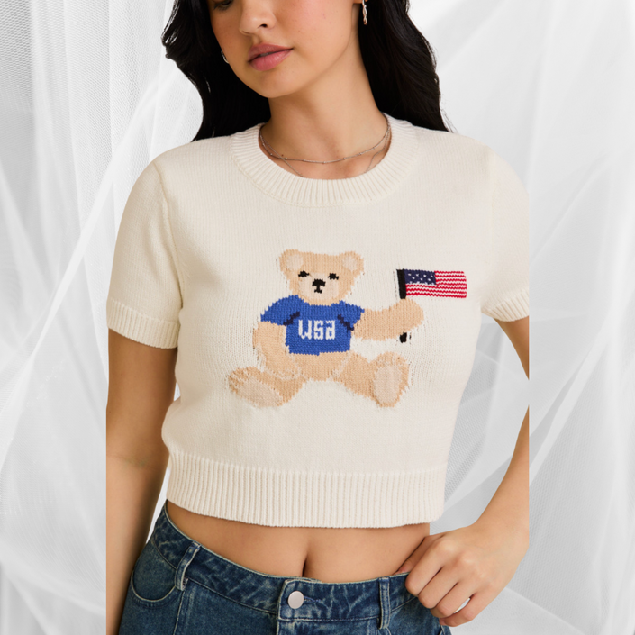 Woman wearing a white USA teddy bear crop top and denim mini skirt – perfect patriotic summer outfit